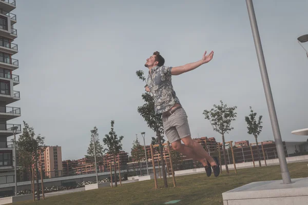 Young handsome man jumping in the street — Stock Photo, Image