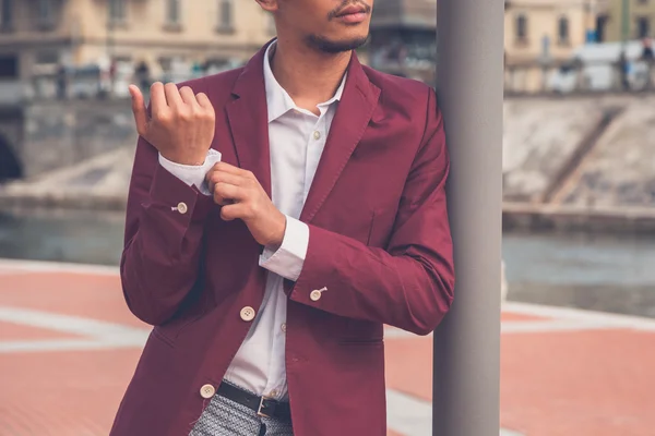 Handsome Asian model posing by an artificial basin — Stock Photo, Image