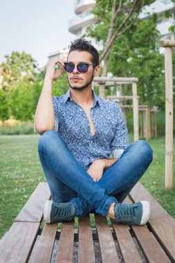 Yakışıklı delikanlı bir şehir parkında poz