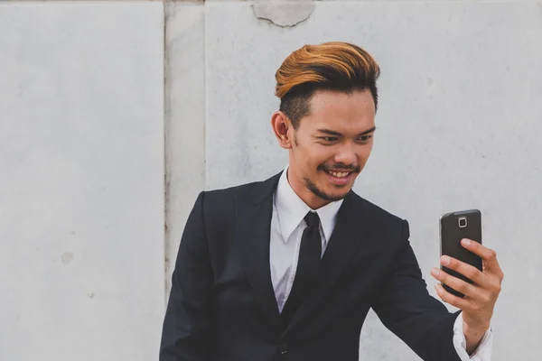 Young handsome Asian model taking a selfie — Stock Photo, Image