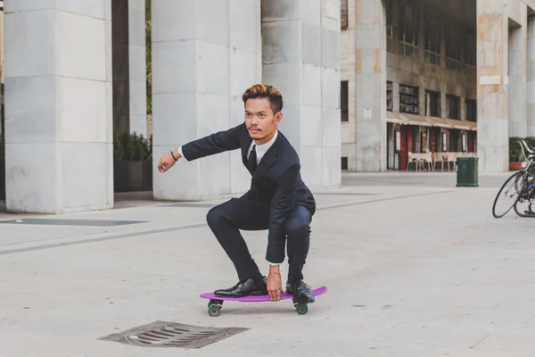 Young handsome Asian model posing with his skateboard — Stock Photo, Image