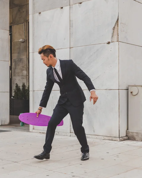 Young handsome Asian model posing with his skateboard — Stock Photo, Image