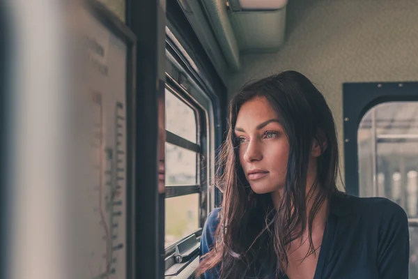 Beautiful girl posing in a metro car — Stock Photo, Image