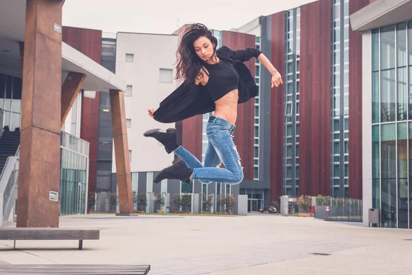 Beautiful girl jumping from a bench — Stock Photo, Image