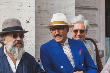 People gather outside Ferragamo fashion show building in Milan,