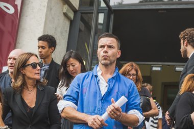 People gather outside Ferragamo fashion show building in Milan,