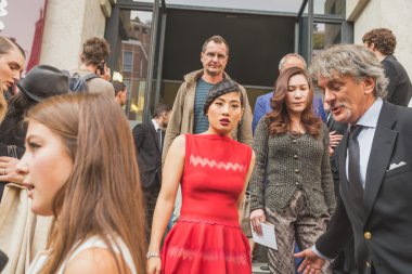 People gather outside Ferragamo fashion show building in Milan,