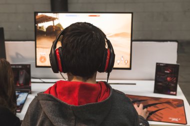 Child playing video games at G come giocare in Milan, Italy