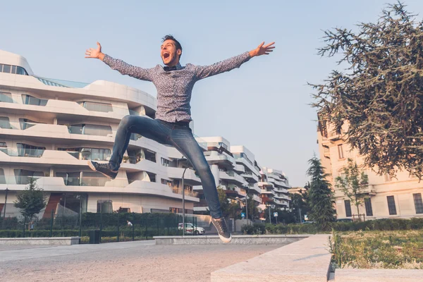 Young handsome man jumping in the city streets — Stock Photo, Image