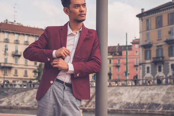 Handsome Asian model posing by an artificial basin — Stock Photo, Image