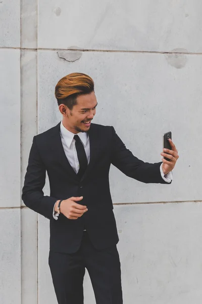Young handsome Asian model taking a selfie — Stock Photo, Image