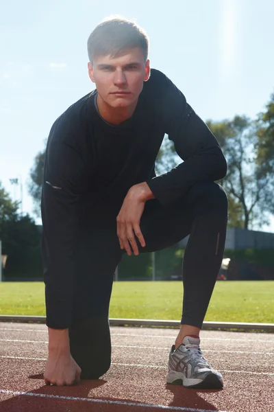 Portrait of sexy muscle man posing on stadium — Stock Photo, Image