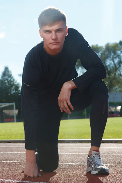 Portrait of sexy muscle man posing on stadium — Stock Photo, Image