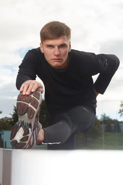 Portrait of sexy muscle man posing on stadium — Stock Photo, Image