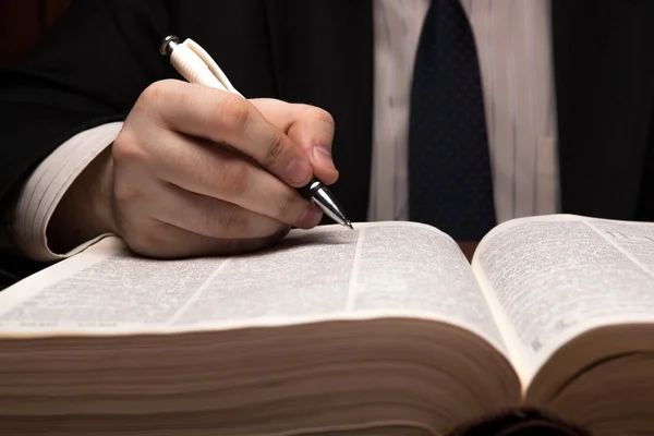 Man is looking for information in the dictionary — Stock Photo, Image