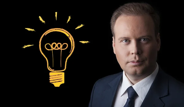 Portrait of a man with an idea on a black background — Stock Photo, Image