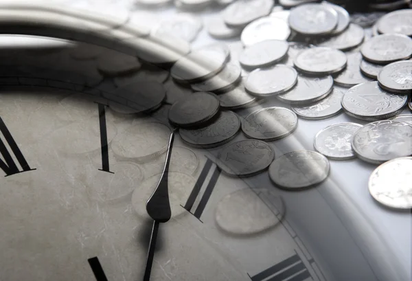 Pile of coins with clock face — Stock Photo, Image