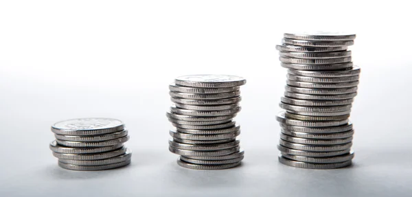 Stacks of coins on a white background — Stock Photo, Image