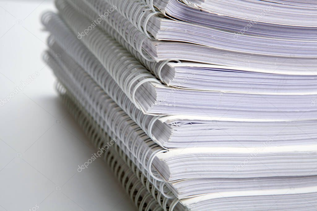 stack of large white notebooks on the desktop close up