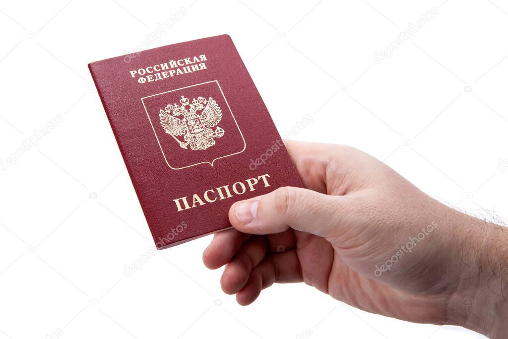 Russian passport in the hand of a man on a white background as identification isolated