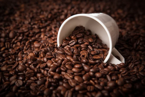 Tazza rovesciata con chicchi di caffè — Foto Stock