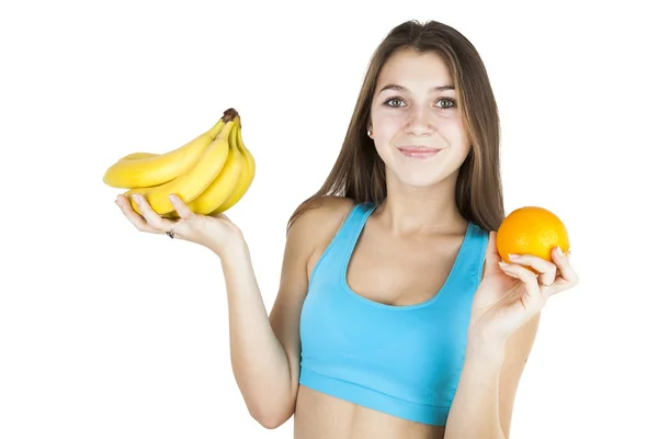 Athletic girl holding fruit — Stock Photo, Image
