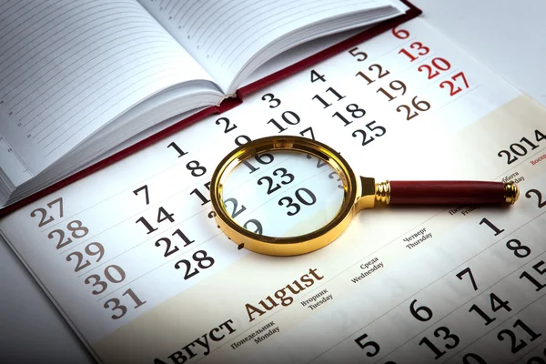 Magnifier on the diary — Stock Photo, Image