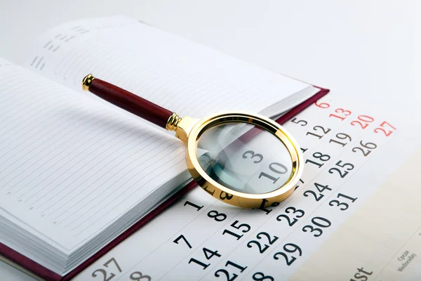Magnifier on the diary — Stock Photo, Image