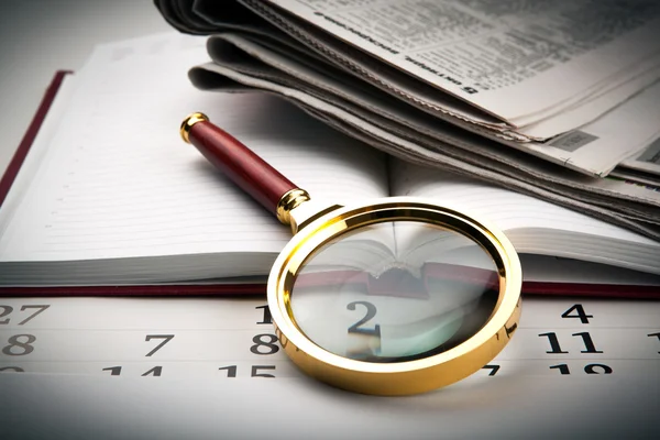 Magnifier on the diary — Stock Photo, Image