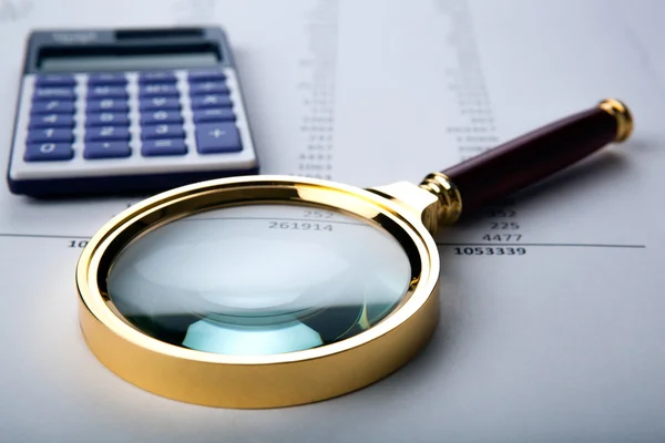 Work with a magnifying glass, a calculator — Stock Photo, Image