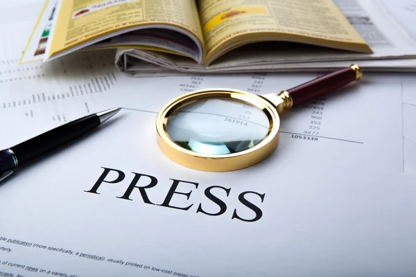 Magnifier and sign the press — Stock Photo, Image