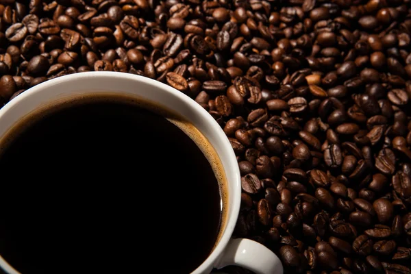 Still-life with a cup of black coffee and roasted coffee beans — Stock Photo, Image