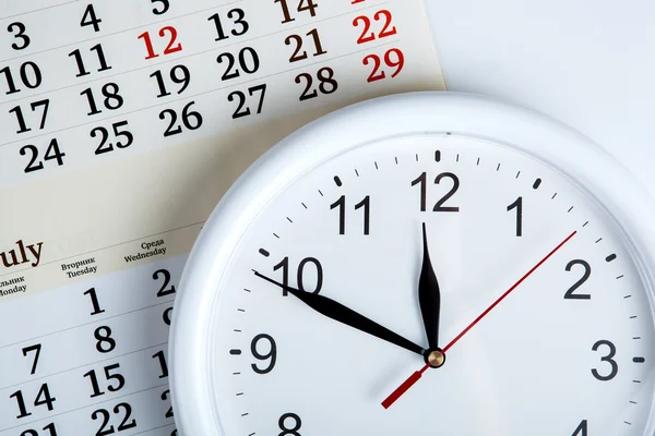 Sheet of a calendar with clockface — Stock Photo, Image