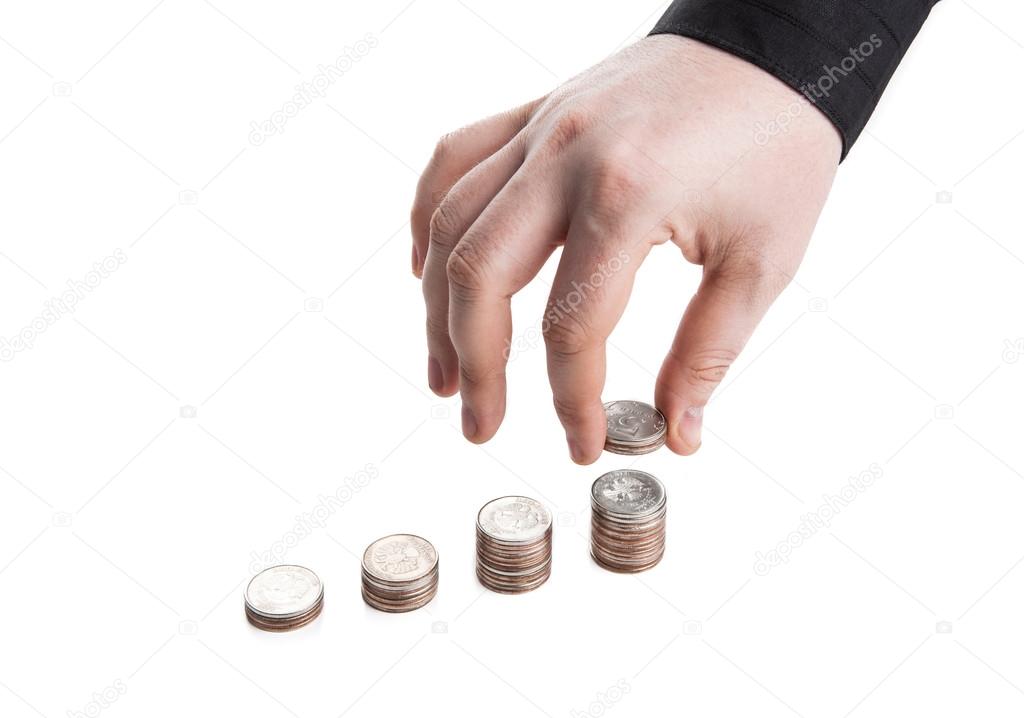 Stack of coins and human hand