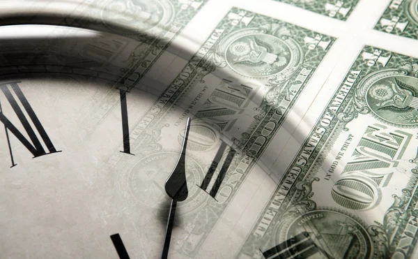 Clock on the background of banknotes dollars — Stock Photo, Image