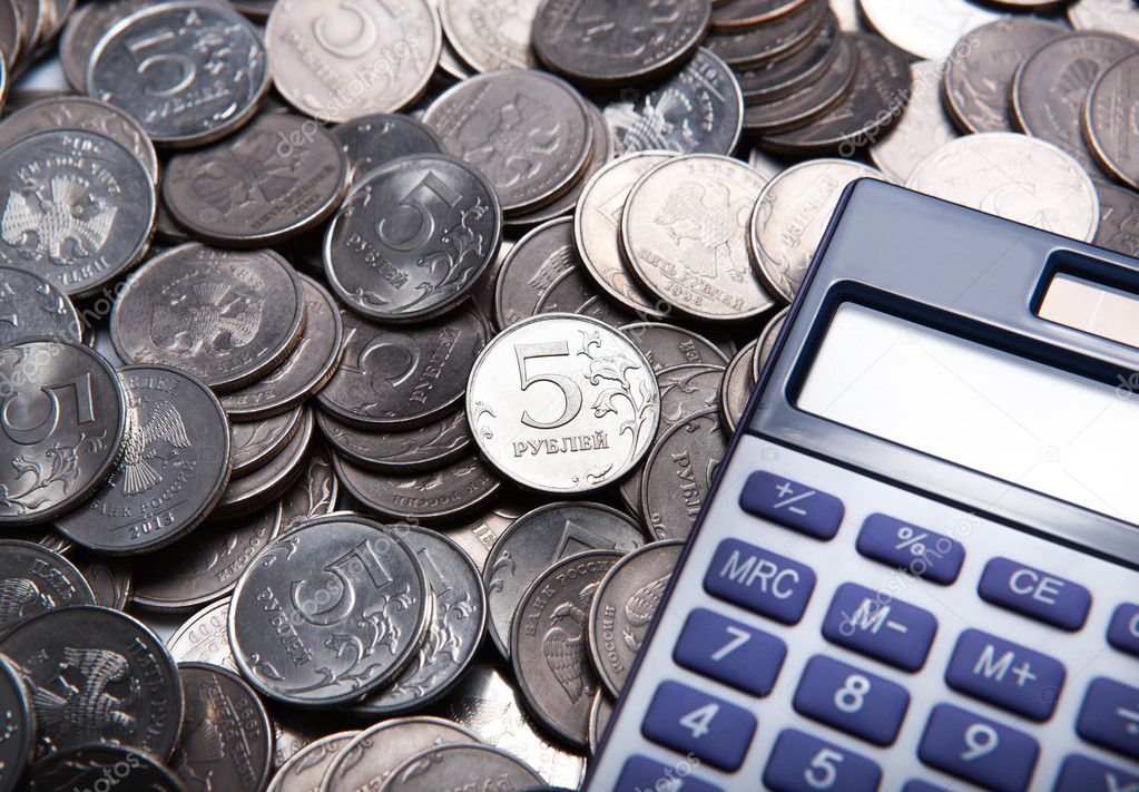 money in the form of coins with calculator