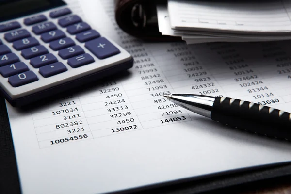 Pen on background of calculator and accounting papers — Stock Photo, Image