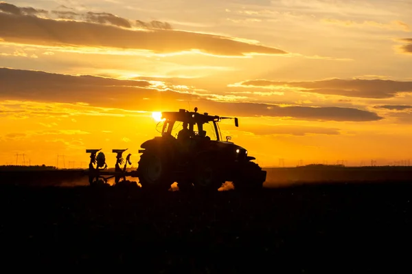 Tractor plowing fields -preparing land for sowing