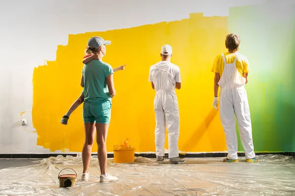 Dos Hombres Pintores Sobre Fondo Amarillo Verde Familia Feliz Renovando —  Fotos de Stock