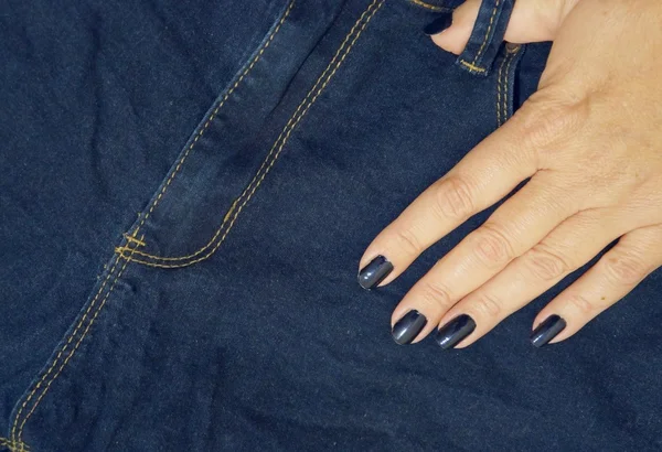 Jeans and a female fingers — Stock Photo, Image