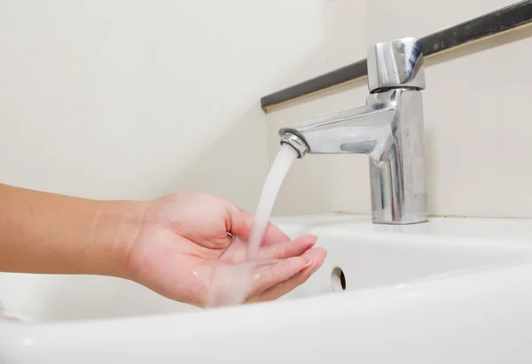 Washing at faucet in the bathroom — Stock Photo, Image