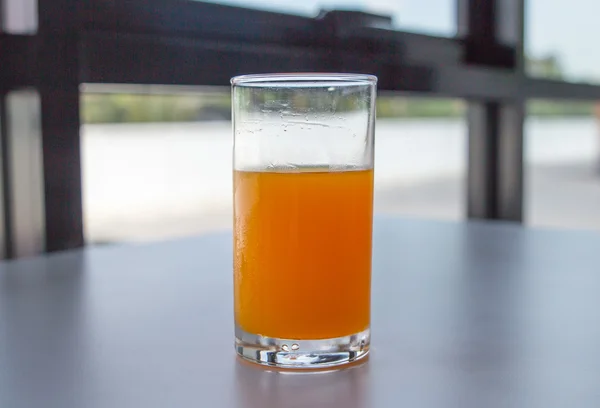 Orange juice glass on Office table background — Stock Photo, Image