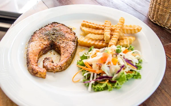 Salmon steak and mashed potato on wood table — Stock Photo, Image