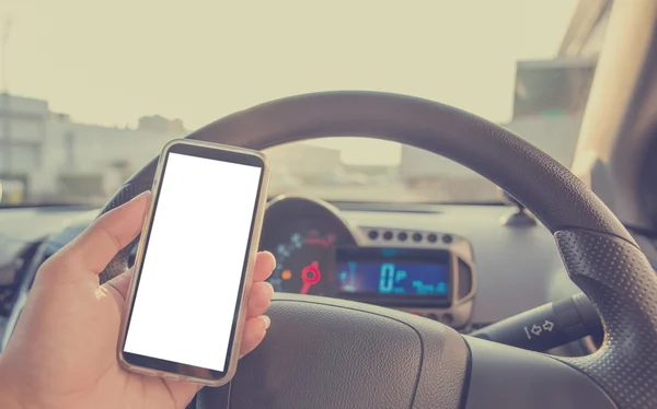 Using cellphone in car with defocused city traffic. Vintage filt — Stock Photo, Image