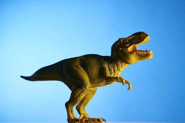 Dinossauro em fundo azul — Fotografia de Stock