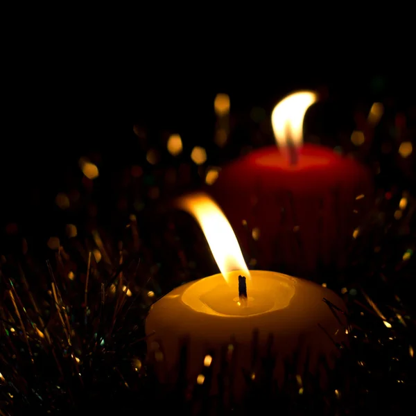 Světlé Vánoční svíčky s šumivým věnec na černém pozadí — Stock fotografie