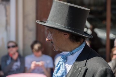 PARIS, FRANCE - MAY 1 2016 - Old dressed man in Montmartre crowded of people for sunday sunny day