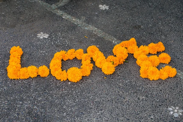Palabra de amor hecha por detalle de flor naranja — Foto de Stock