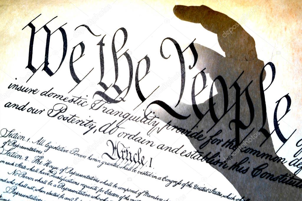 hand fingers catching american constitution we the people