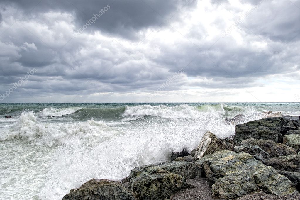 sea in tempest on rocks of italian village
